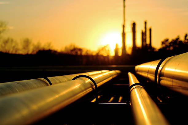 Golden pipes going to oil refinery Golden pipes going to oil refinery pipeline stock pictures, royalty-free photos & images