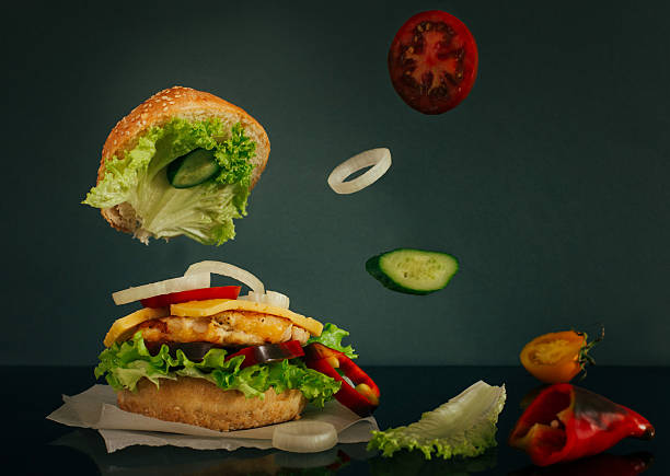 istock Delicious burger with flying ingredients on dark background 497319204