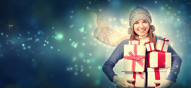 istock Happy young woman holding many present boxes 497319656