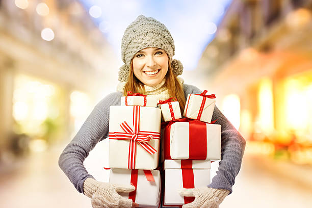 istock Happy young woman holding many present boxes 497319682