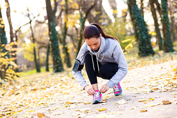 istock Runner is tying laces and listening to music. 497320380