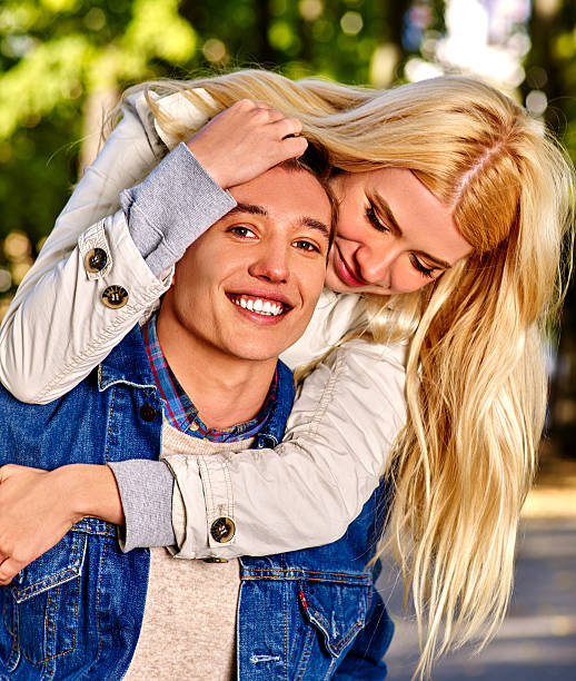 istock Young couple hugging and flirting in  park 497320476