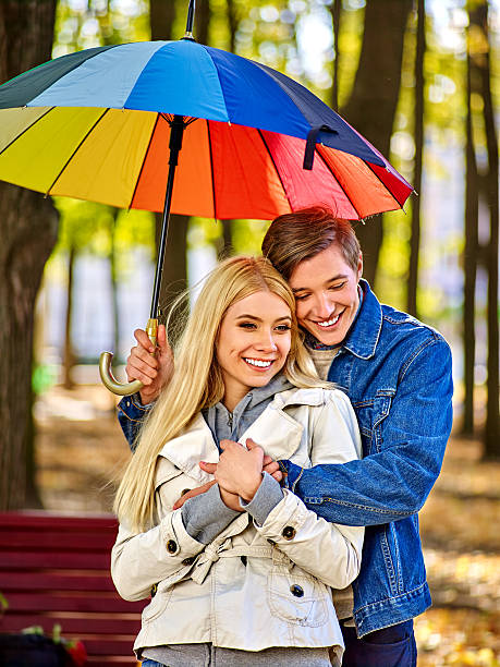 istock Loving couple on a date under umbrella 497320628