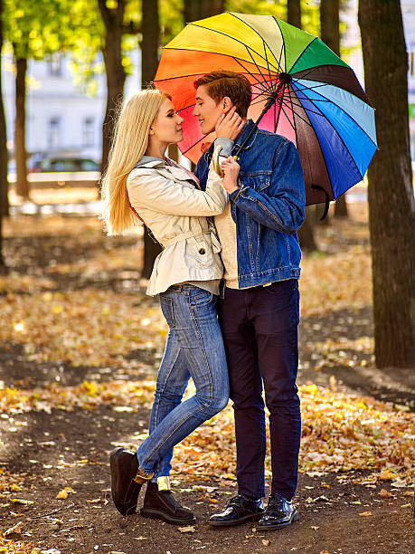 istock Loving couple on a date under umbrella 497320642