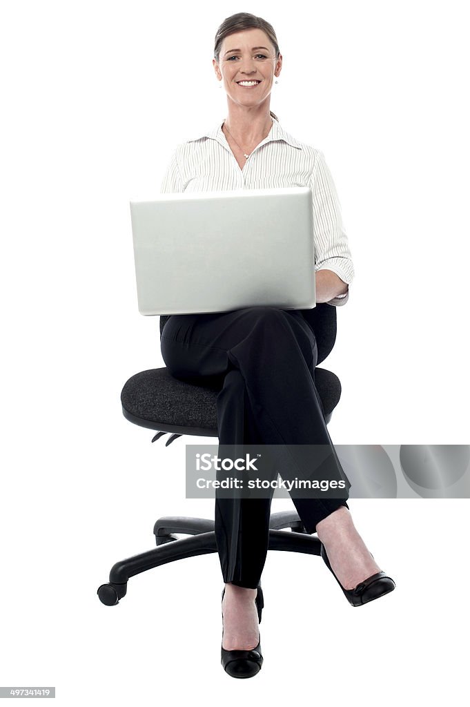 Corporate lady working on her laptop Businesswoman sitting on the chair and working Adult Stock Photo