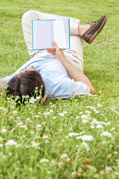 istock Full length of young man holding book 497341685