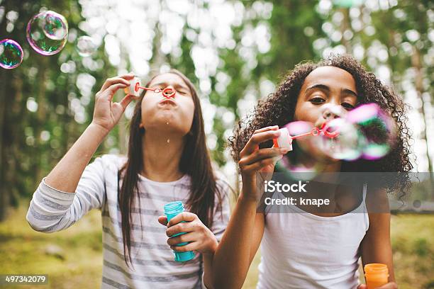 Cute Girls Blowing Bubbles Outdoors Stock Photo - Download Image Now - Child, Playing, Playful