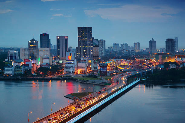Johor Bahru The Malaysian city of Johor Bahru, with heavy traffic on the Johor-Singapore Causeway at dusk. johor bahru malaysia stock pictures, royalty-free photos & images