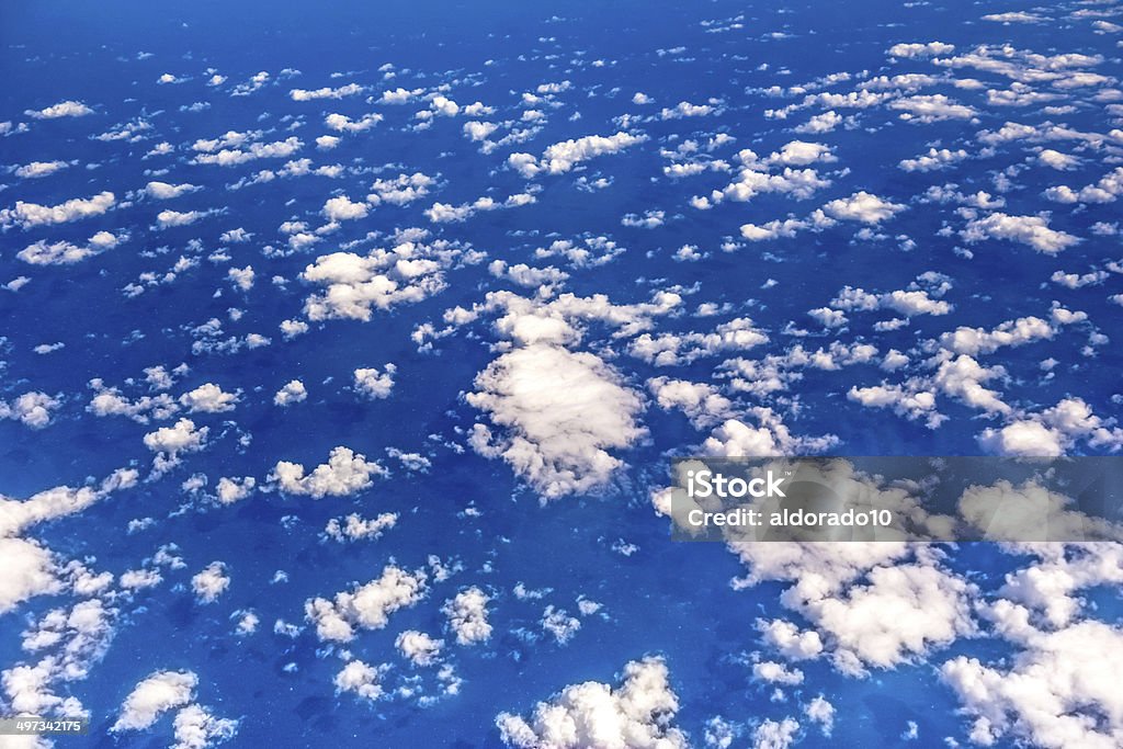 Over the clouds over the clouds, view during a flight over the blue ocean Air Vehicle Stock Photo