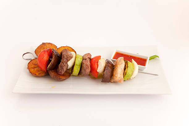 istock kebab beef,chicken and pork meat  grilled with vegetables 497343438