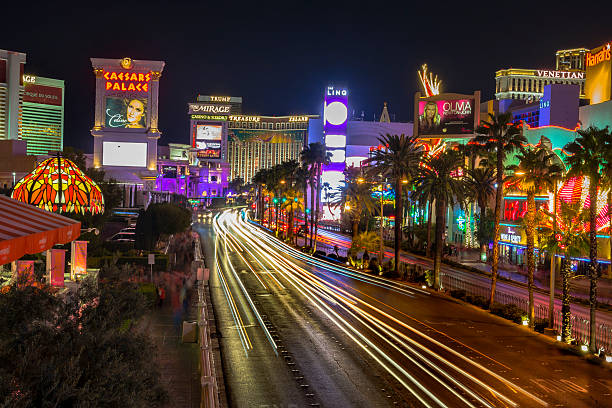 Las Vegas Boulevard. The strip. Las Vegas, USA - September 24,2015 - Photo taken at Las Vegas Boulevard.  Caesars Palace, The Mirage are in this picture from Las Vegas, under a night sky.  Photo taken at horizontal orientation. Many cars and people on the street. the strip las vegas stock pictures, royalty-free photos & images