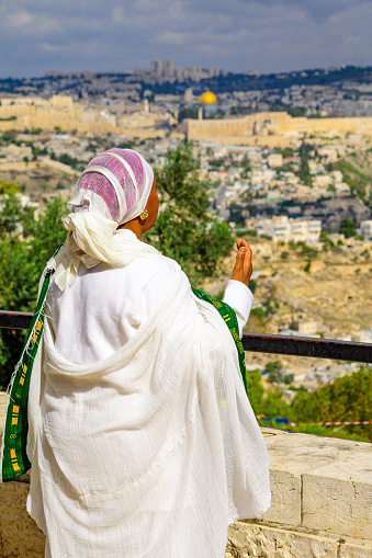 Jerusalem, Israel - November 11, 2015: An Ethiopian Jewish woman pray at the Sigd, facing the old city, in Jerusalem, Israel. The Sigd is an annual holiday of the Ethiopian Jewry
