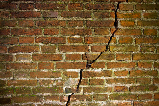 Cracked brick wall Cracked brick wall crevice photos stock pictures, royalty-free photos & images