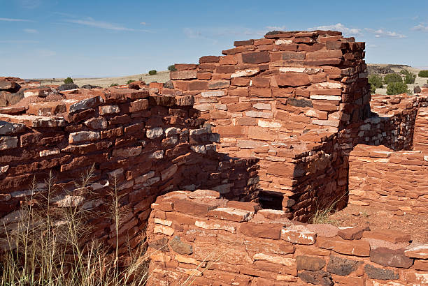 Nalakihu Pueblo Dwelling Nearly a thousand years ago natives inhabited the plains between the Painted Desert and the San Francisco Peaks of Arizona. In an area so dry it would seem impossible to live, they built pueblos, harvested rainwater, grew crops and raised families. Today the remnants of their villages dot the landscape. Nalakihu Pueblo is in Wupatki National Monument, established in 1924 to preserve this rich heritage. Wupatki National Monument is near Flagstaff, Arizona, USA. chinle formation stock pictures, royalty-free photos & images