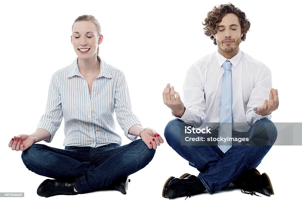 Business people practicing meditation Business executives meditating in lotus posture Adult Stock Photo