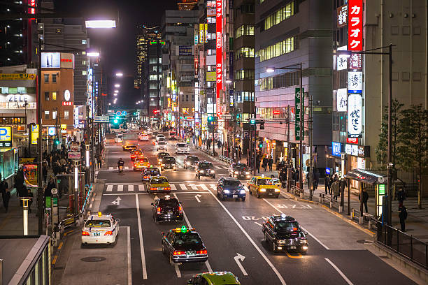 istock Rush hour commuters in neon night city downtown Tokyo Japan 497345122