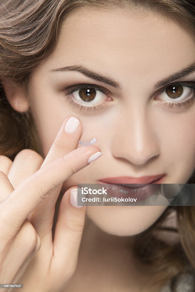 contact lens contact lens on finger of young woman looking on camera Adult Stock Photo