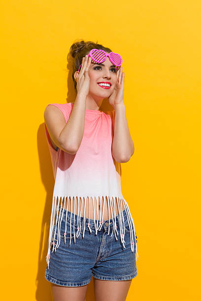 istock Girl against yellow wall 497347351