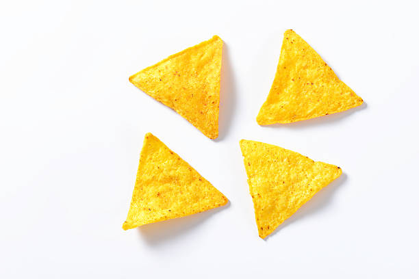 nachos - tortilla chips four nachos - tortilla chips isolated on white background nacho chip stock pictures, royalty-free photos & images