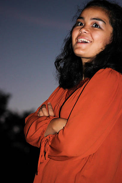 istock Smiling Hispanic Teenager Poses While Looking Up 497347882