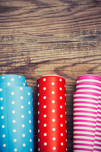 istock Rolls of colored wrapping paper on wooden background 497347909