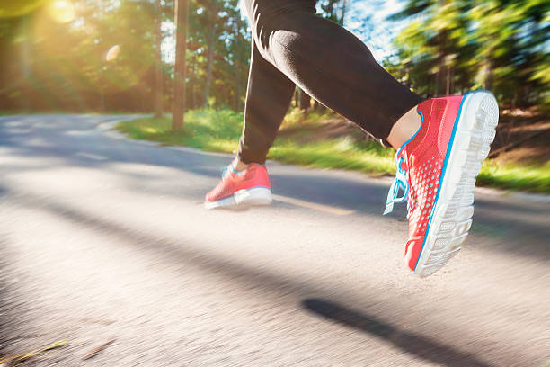 istock Woman jogging down an outdoor trail 497348198