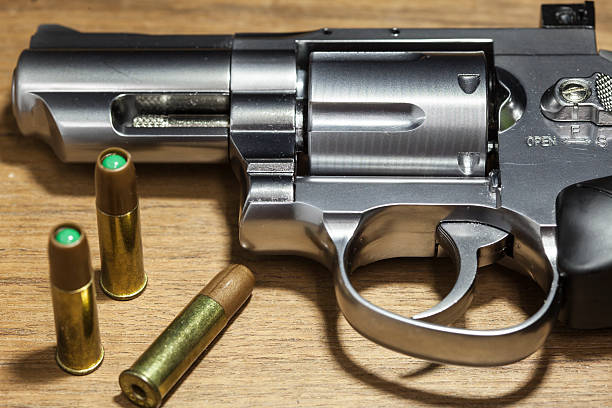 istock close -up air gun on old wood background. 497348254