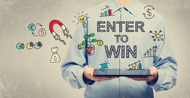 istock Enter to Win concept with man holding a tablet 497348470