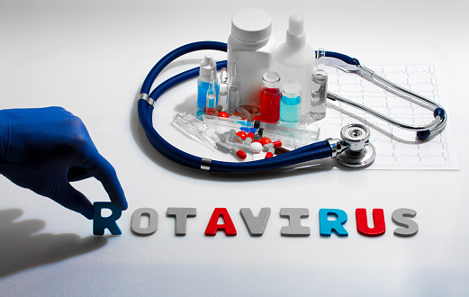 Diagnosis - Rotavirus. Medical concept with pills, injection, stethoscope, cardiogram and a syringe