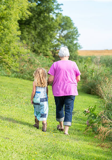 istock Girl & Grandma Going For Walk on Farm 497349478