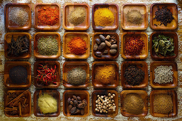 istock Indian spices in wooden trays. 497353956