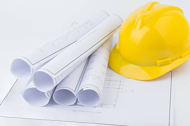 istock Yellow safety helmet and plan drawing 497354394