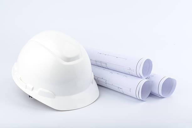 istock White safety helmet and paper 497354670