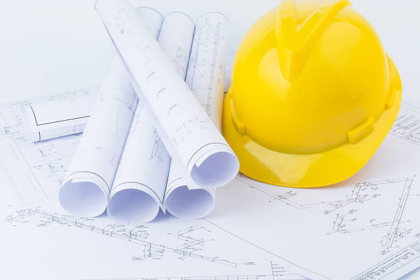istock Yellow safety helmet and plan drawing 497354994