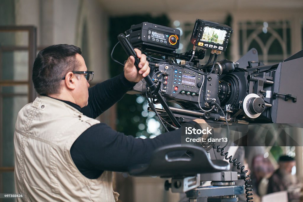 Professional camera man at work Camera operator with modern professional equipment working during film shooting Movie Stock Photo