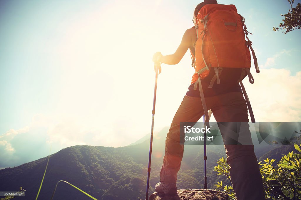 successful woman hiker climbing to mountain peak Hiking Stock Photo