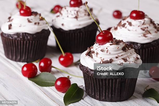 Chocolate Cupcakes With Cream And Fresh Cherry Horizontal Stock Photo - Download Image Now