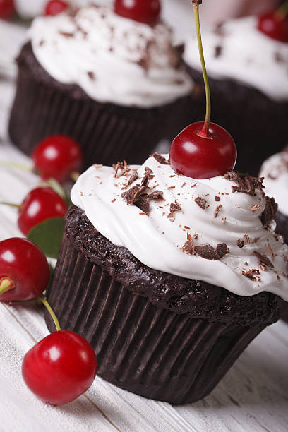 istock delicious chocolate cupcakes with cherry close up, vertical 497356778