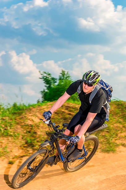 istock dynamic picture of a cyclist in motion on mountain road 497356814