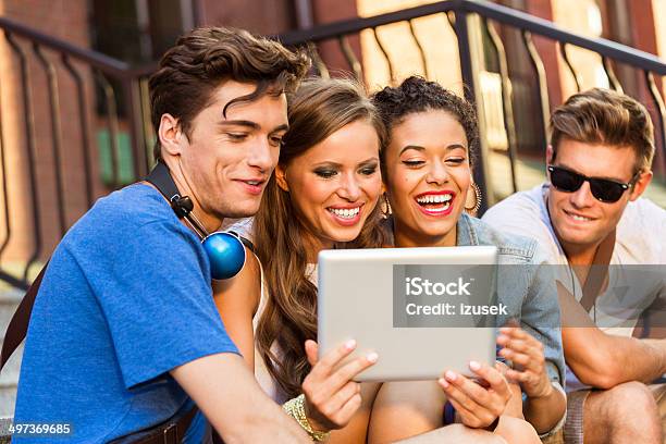 Friends Using Digital Tablet Stock Photo - Download Image Now - 20-24 Years, Adolescence, Adult