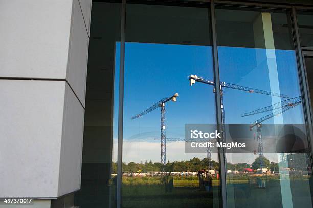 Construction Cranes Reflected In Window Stock Photo - Download Image Now - Architecture, Blue, Building - Activity