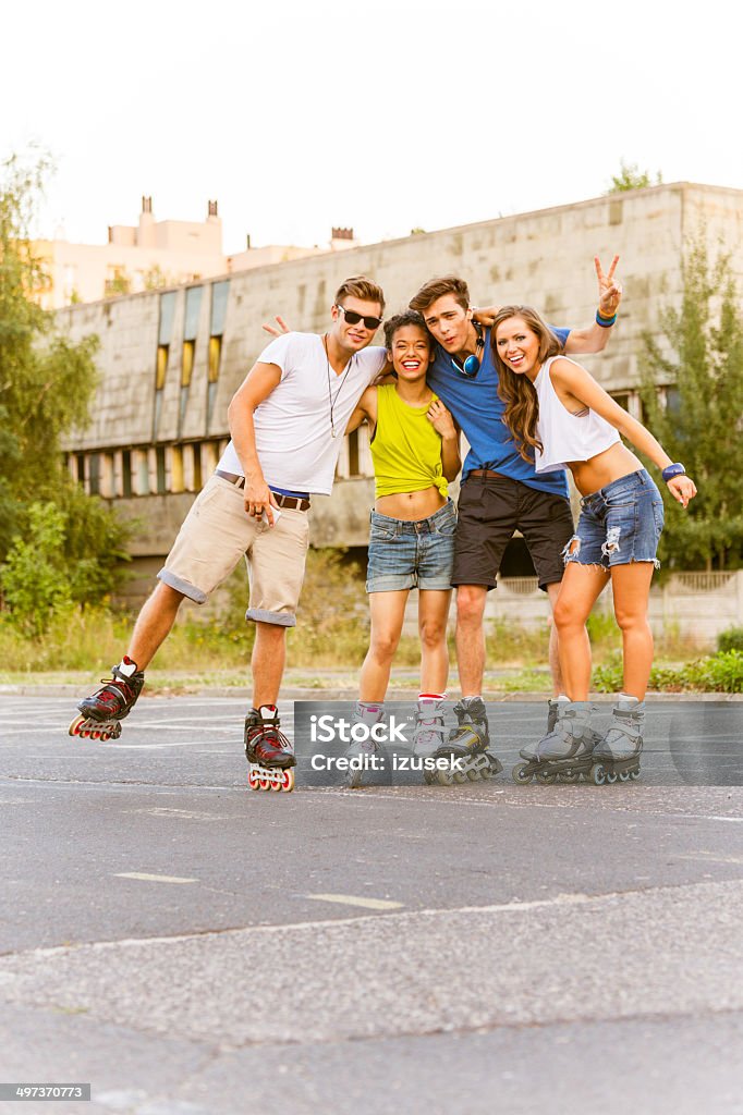 Young people on rollerblades Group of happy young people rollerblading together, smiling at the camera. Fun Stock Photo