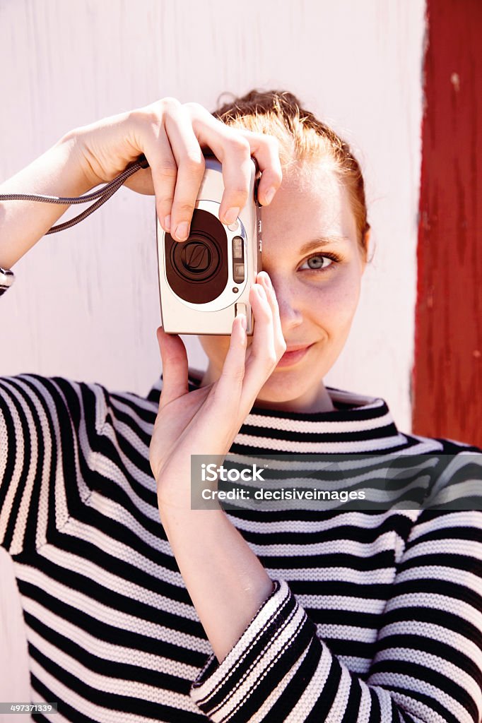 Retro photographer girl A beautiful hipster girl wearing a striped top and holding a retro camera. 20-29 Years Stock Photo