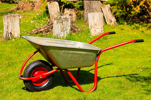 istock Gardening. Garden wheelbarrow with sand soil. 497372115
