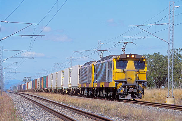 istock Electric cargo train speeding through rural countryside 497372233