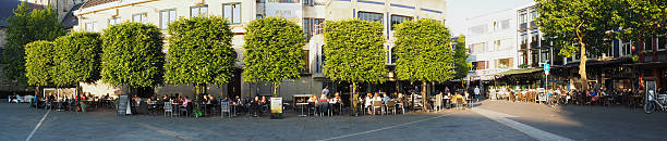 Heerlen, Netherlands - May 16, 2014: Terraces in the centre  of the Dutch city Heerlen. People taking a refreshment in the late evening sun on a square in the centre of Heerlen.