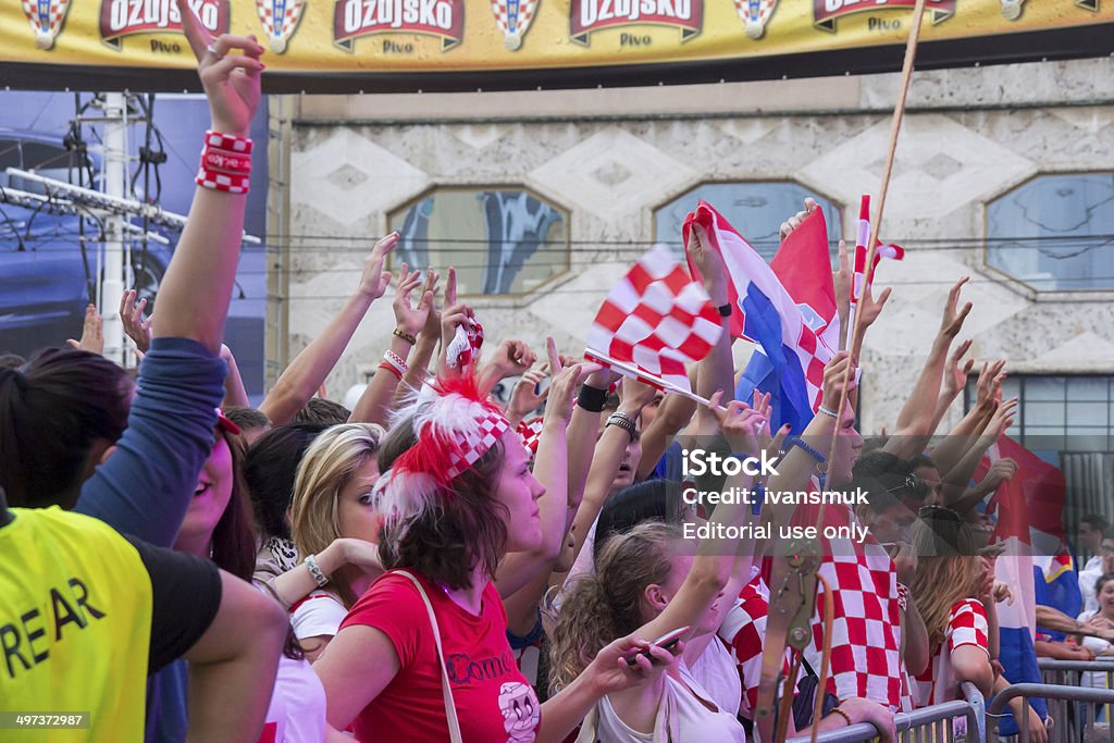 Croatian football fans Zagreb, Croatia - June 14, 2012: Croatian football fans on the main square, watching EURO 2012 match Italy vs. Croatia. Adult Stock Photo