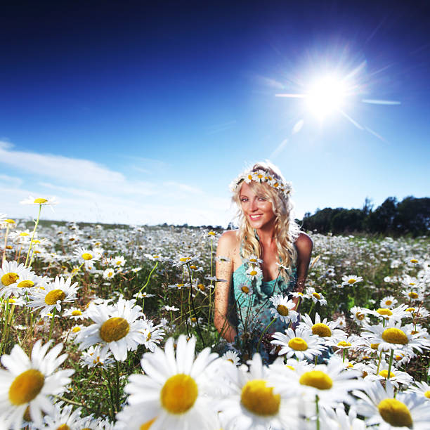 Young smiling girl holding fresh picked flowers from garden.