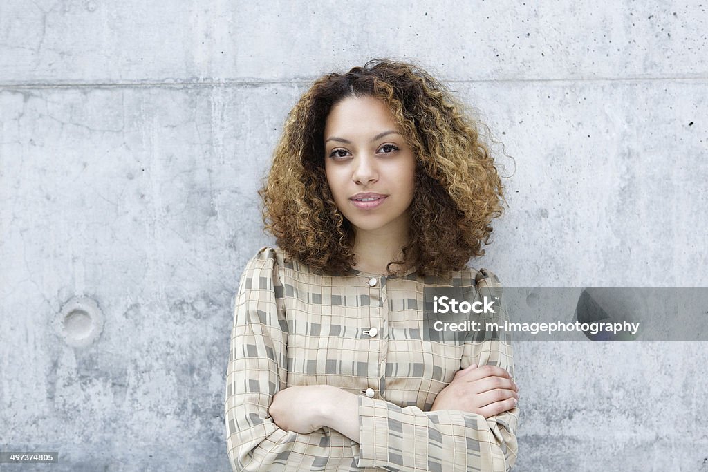 Woman posing outdoors with arms crossed Close up portrait of a young woman posing outdoors with arms crossed Women Stock Photo