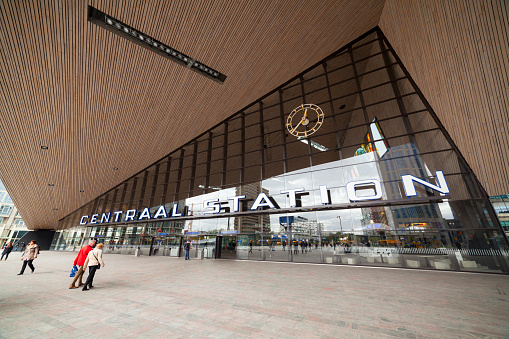 Rotterdam, The Netherlands - April 15, 2014: Rotterdam Central Station exterior with travelers walking in and out. The station was newly opened in 2014